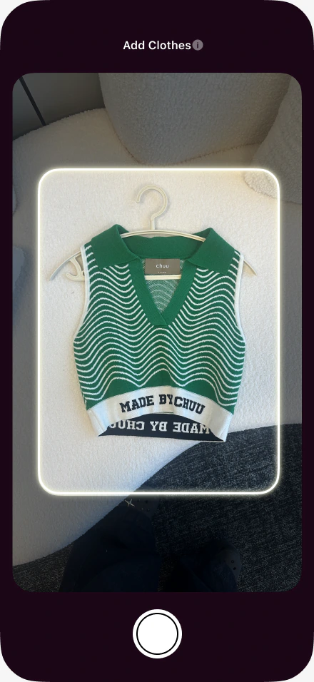 The FITPOP app photographing a green knit top to add it to a digital closet